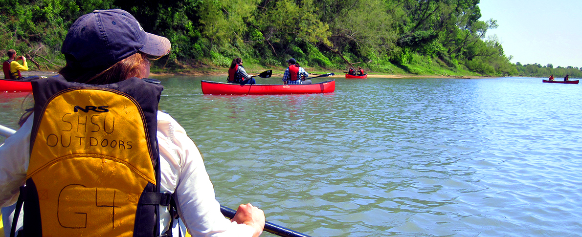 People in Canoes on Water